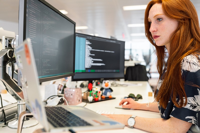 Woman coding at computer